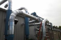 Piping coming from the material handling fans to the slant screen separators.