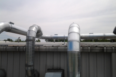 Piping coming from the material handling fans bending up on the roof to the slant screen separators.