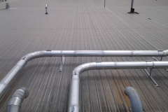 Piping running along the roof from the material handling fans to the slant screen separators.