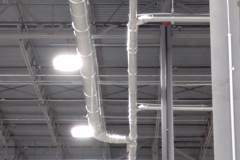 Piping from the cutters merging into one of two main pneumatic conveying lines.
