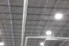 Two main pneumatic conveying lines running inside of the building and penetrating the outside wall.